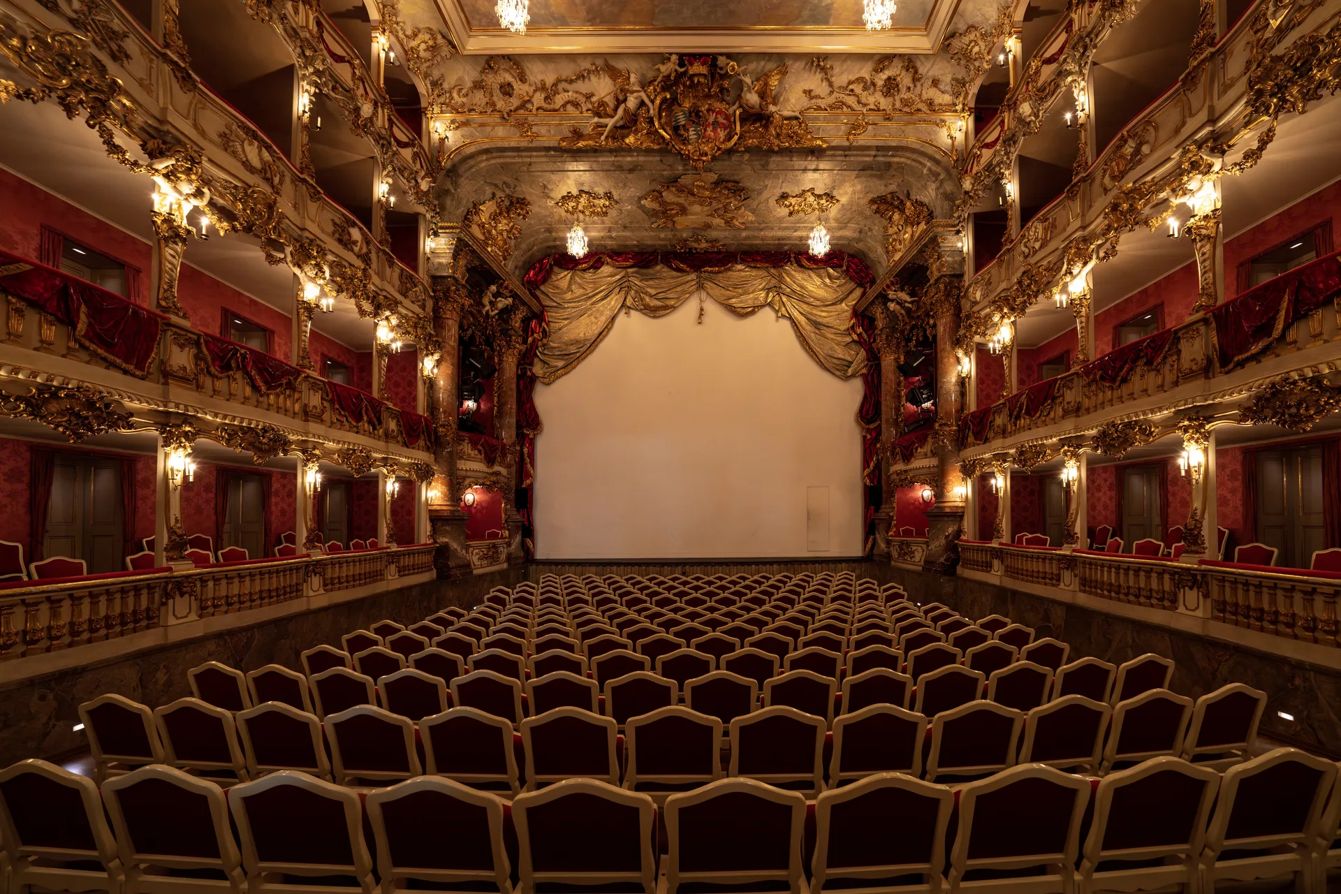 The gilded four-tier auditorium of the Cuvilliés Theatre, rows of red and gold boxes facing an empty stage